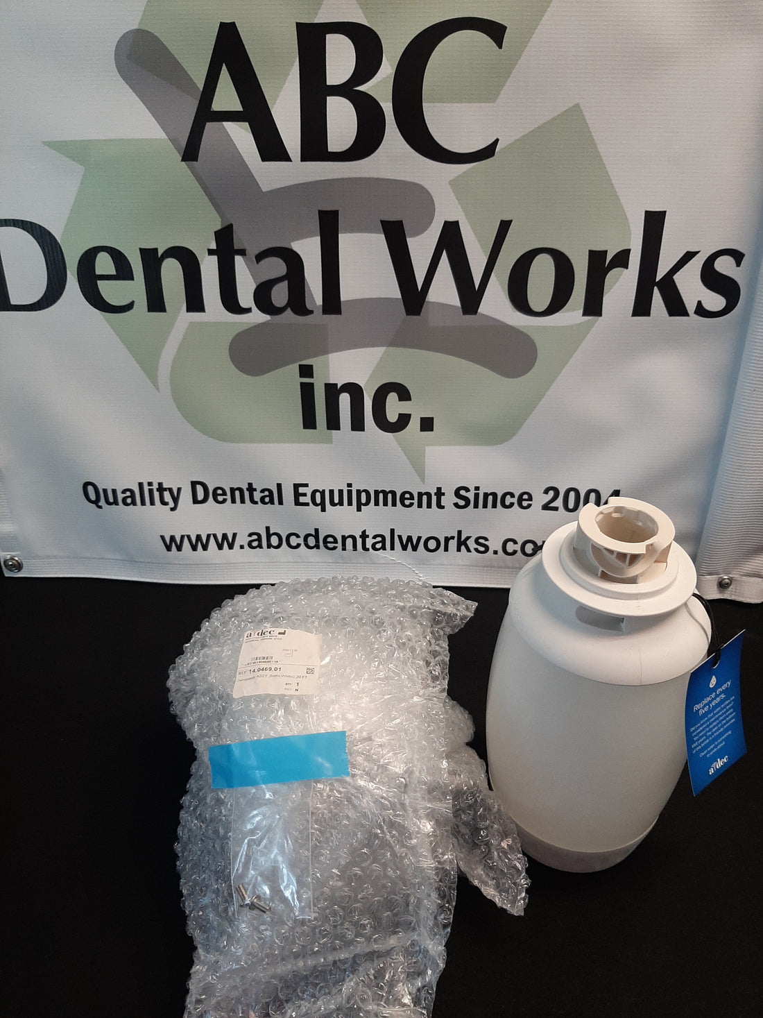 A-dec Water Bottle Kit with Radius Post Mount Assembly, Part #14.0484.00 — installed view