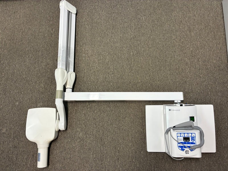 Belmont Belray 097 II x-ray unit disassembled on carpet: scissor extension arm with tube head, plus the control panel and wall plate.