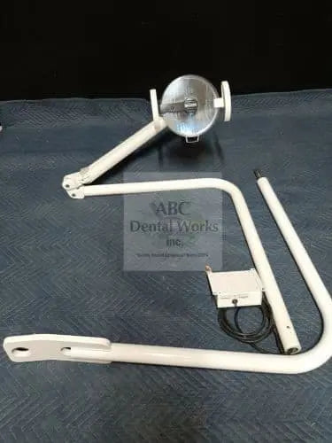 Belmont IO5000 Clesta AL-520X light head on its curved swing-mount arm, laid out on a blanket