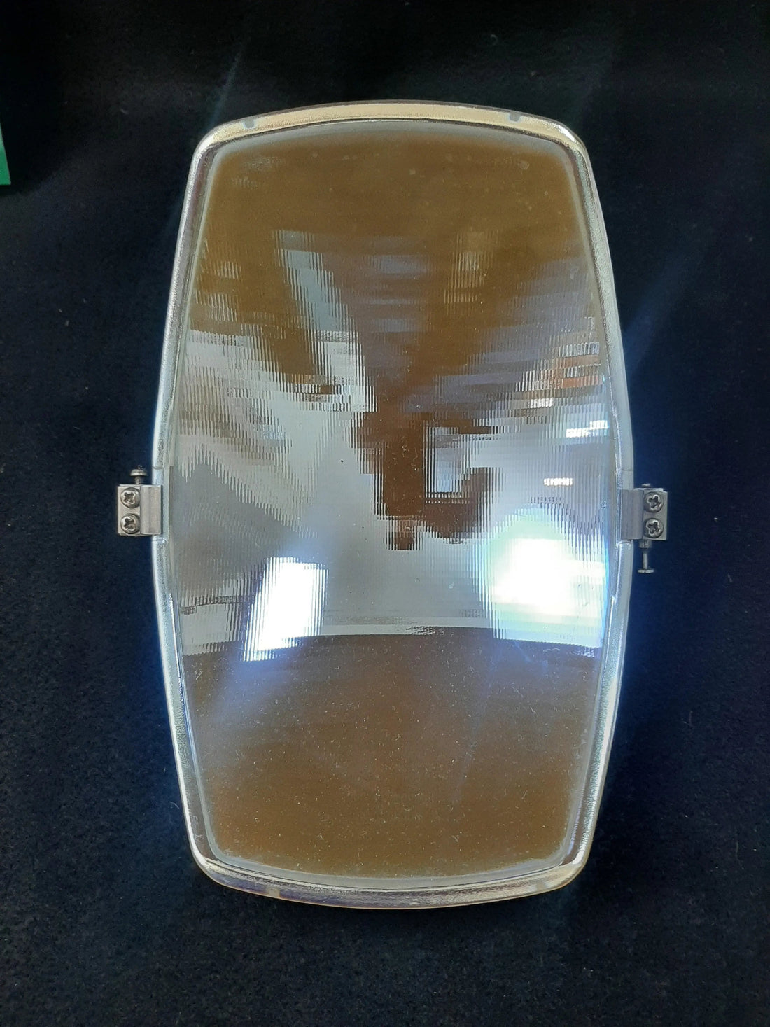 Pelton Crane LF2 reflector lens assembly with hinge rail, front view