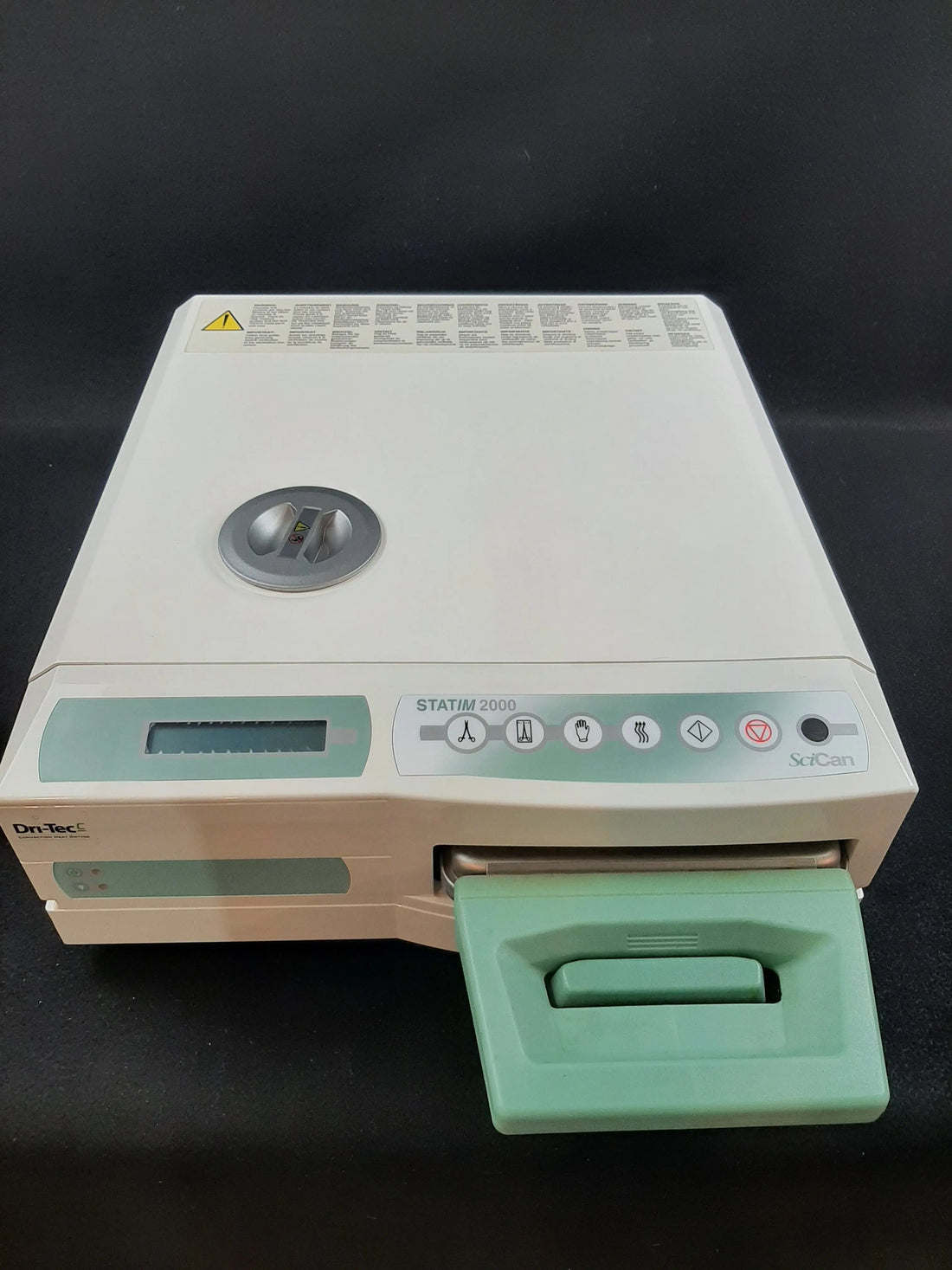 SciCan STATIM 2000 cassette autoclave, front left three-quarter view with the cassette drawer pulled out and Dri-Tec badge visible.
