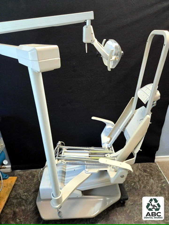 Refurbished A-dec 1021 dental chair with A-dec 6300 operatory light, side view, no upholstery