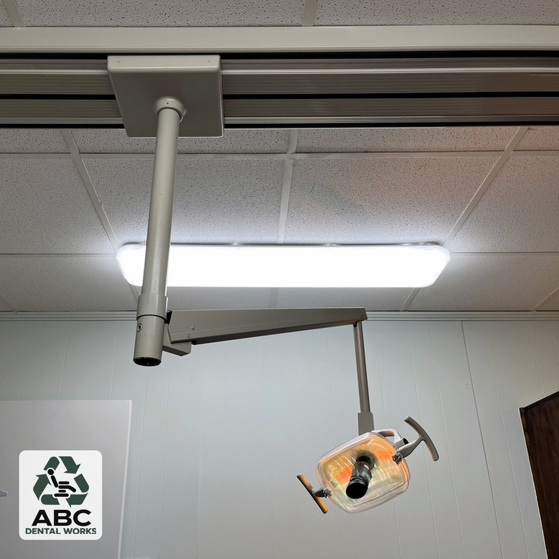 Used A-dec 6300 track mount dental operatory light – ceiling track, down post, arm and light head