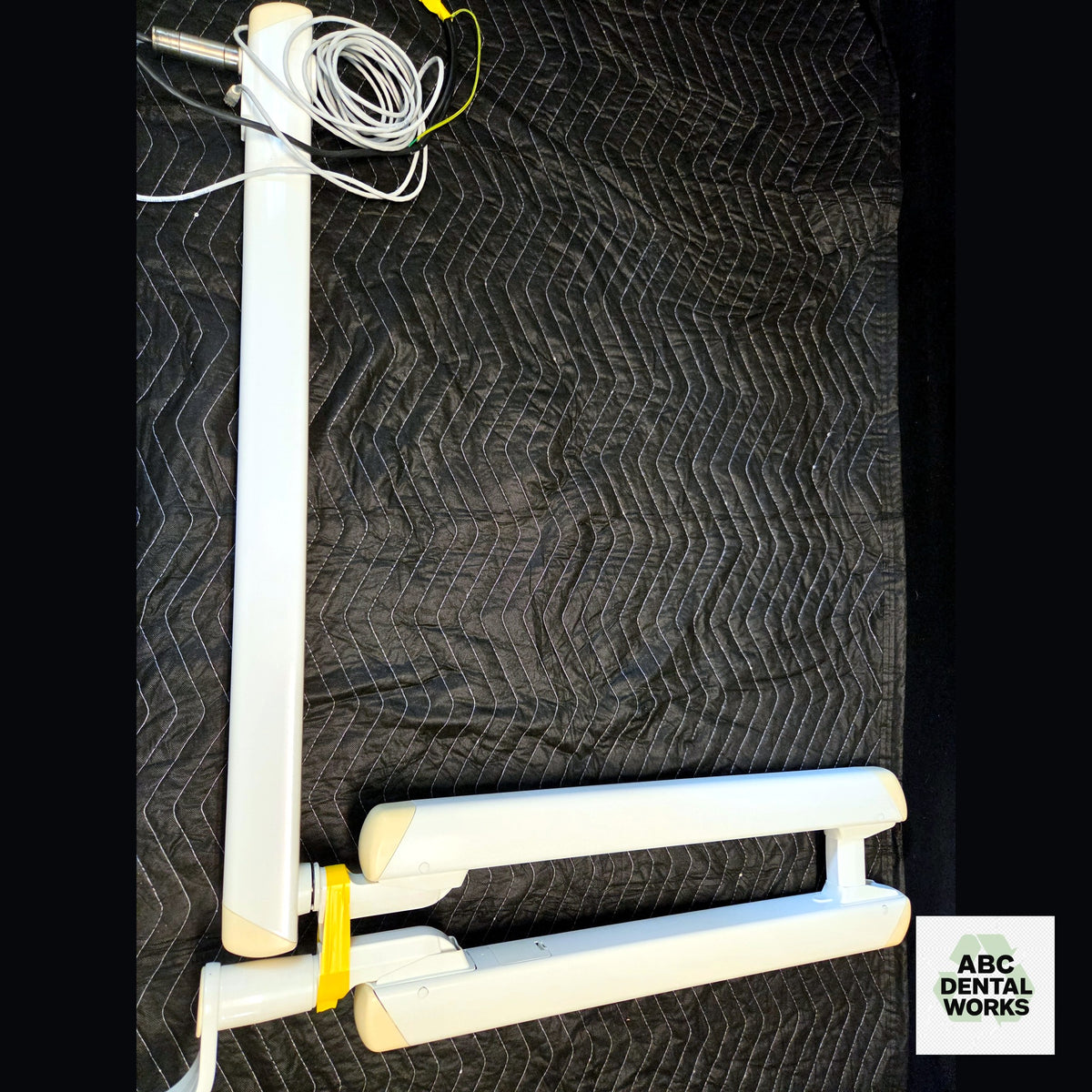 Used Planmeca ProStyle Intra X-ray arm assembly, full view: horizontal wall arm with cabling and folded scissor extension arm