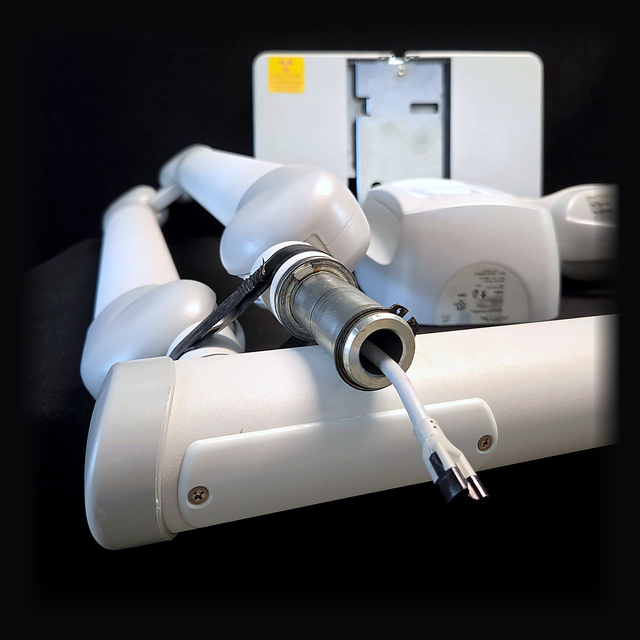 Progeny Preva scissor arm pivot and extension arm joint with new main cable exiting the arm, tube head and control panel behind