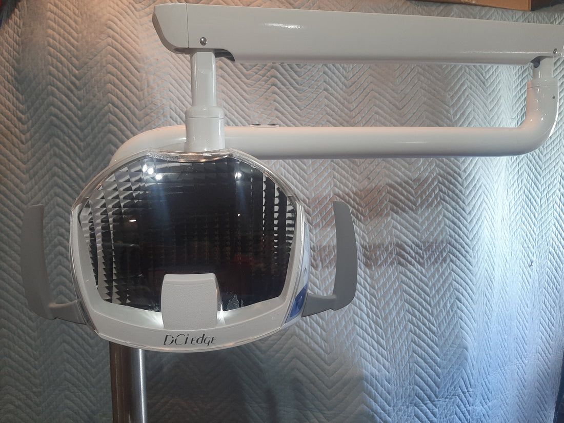 DCI Edge LED operatory light head, front view of the faceted reflector and handle wings; same photo used on the light grey listing.