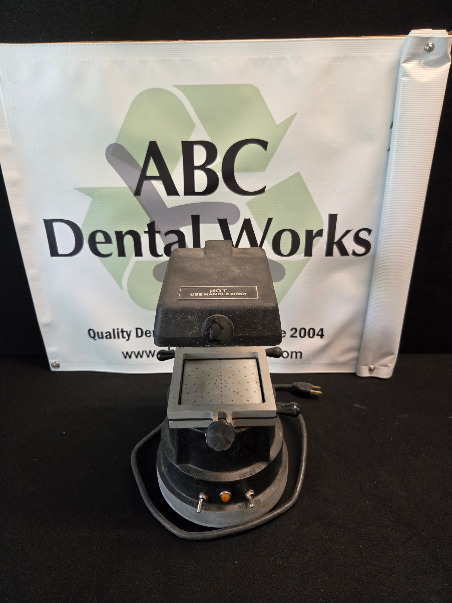 Cast base of the Buffalo Dental vacuum former showing the HEATER and MOTOR toggle switches and pilot lamp