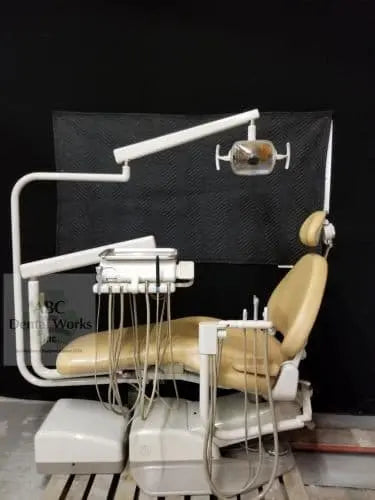 Refurbished A-dec 1040 Cascade dental chair in beige upholstery with radius-mount delivery unit and operatory light