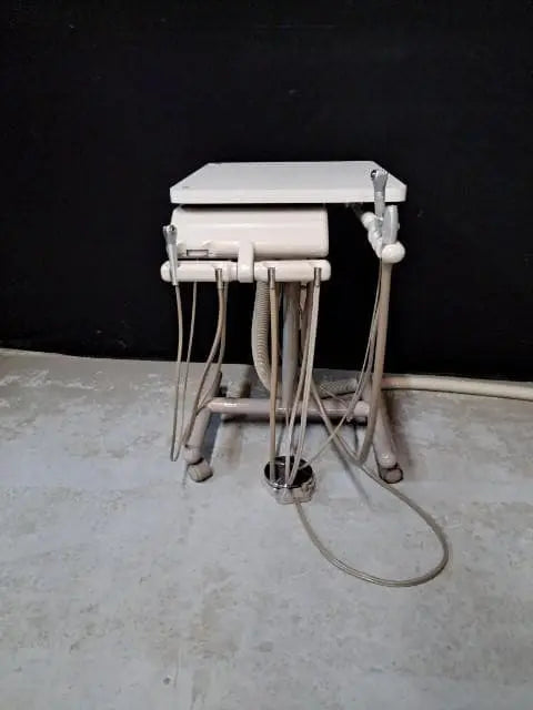 A-dec Cascade 2671 Duo Cart mobile delivery system, front view with handpiece tubing on casters
