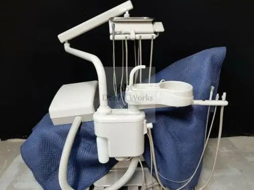 A-dec Cascade traditional delivery unit with post-mounted cuspidor bowl and over-the-patient tray arm, on a dark backdrop