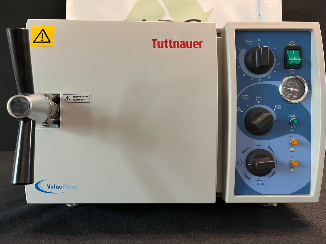 Tuttnauer 1730 Valueklave autoclave front view, door closed with black handle, blue control panel and Valueklave badge.