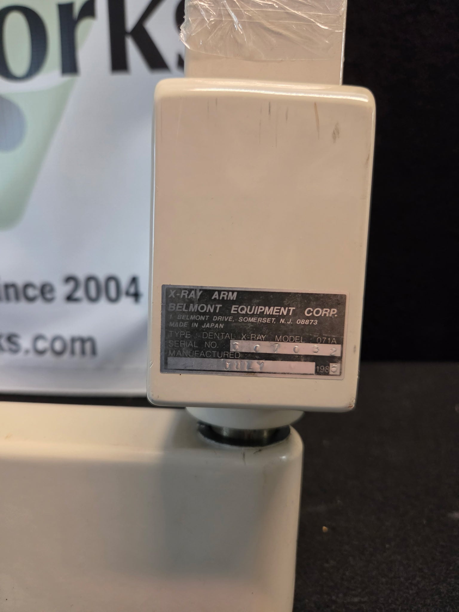 Belmont Equipment Corp. data plate on the 071A X-ray arm showing model 071A, serial number 6070032 and July 1986 manufacture date