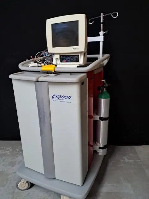 Waterloo ER2000 crash cart, front view with doors closed, a patient monitor and IV pole on top and an oxygen cylinder in the side bracket.