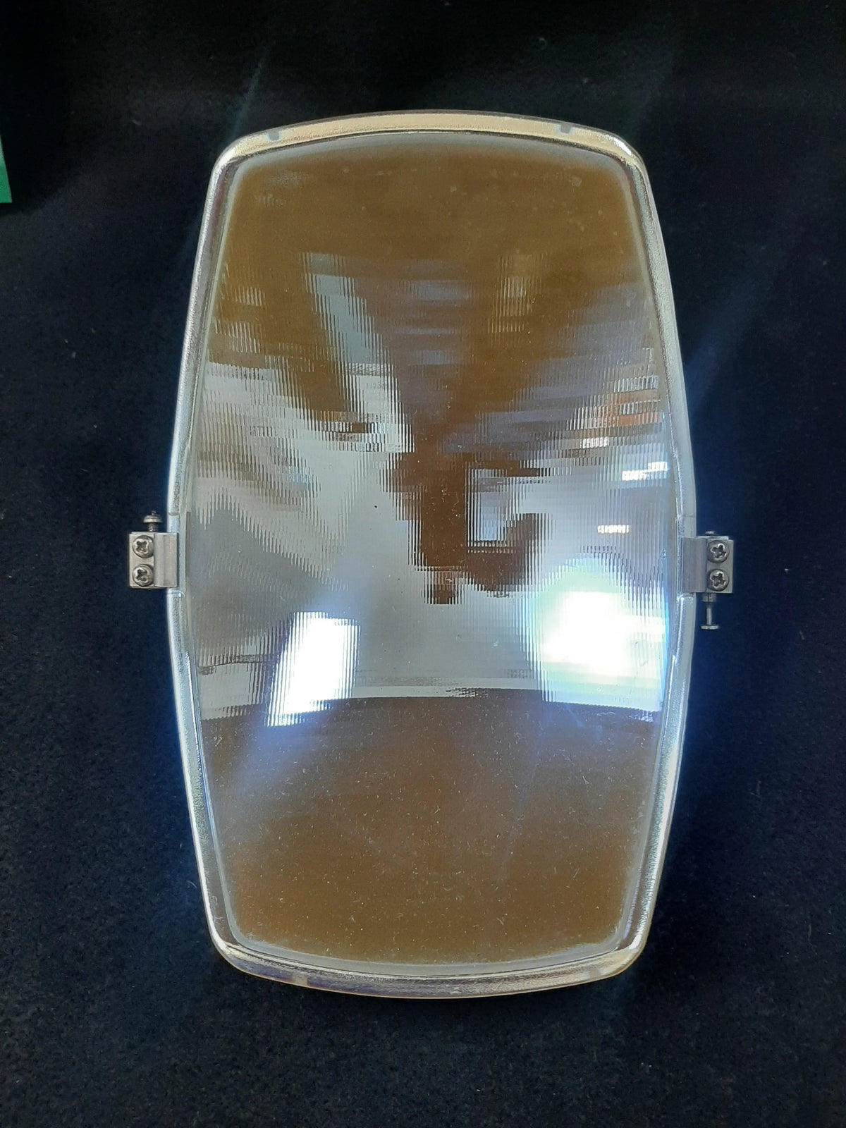Pelton Crane LF2 reflector lens assembly with hinge rail, front view