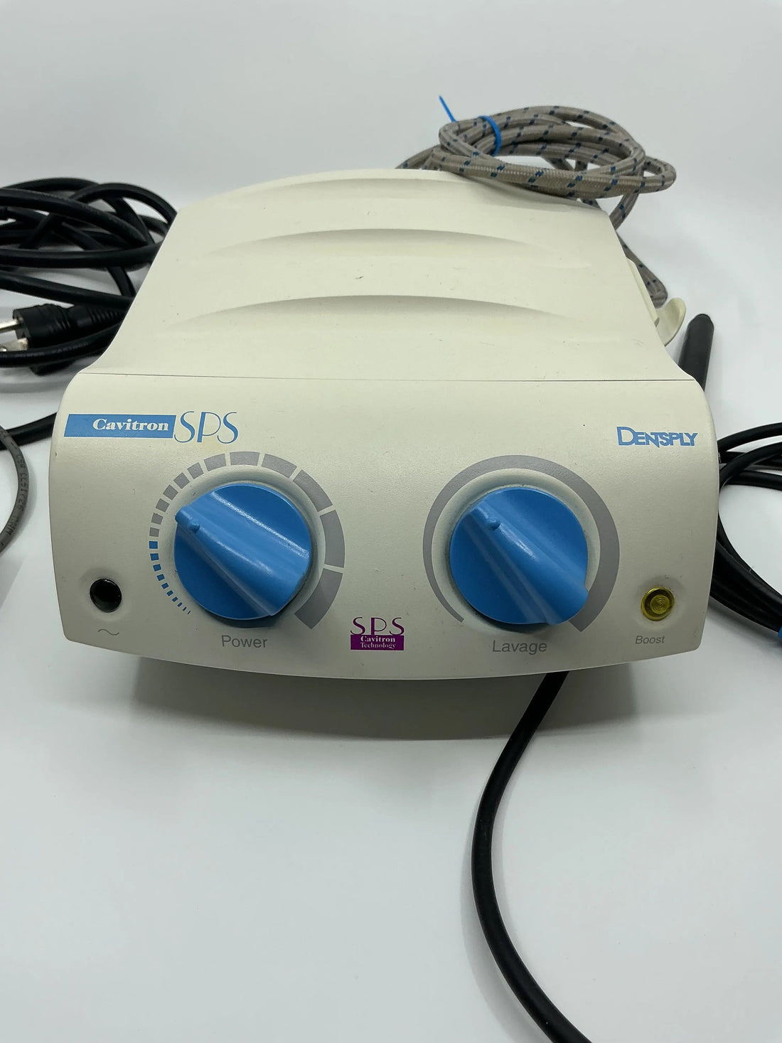 Dentsply Cavitron SPS ultrasonic scaler base, front close up with blue Power and Lavage knobs, handpiece cable and power cord coiled behind.