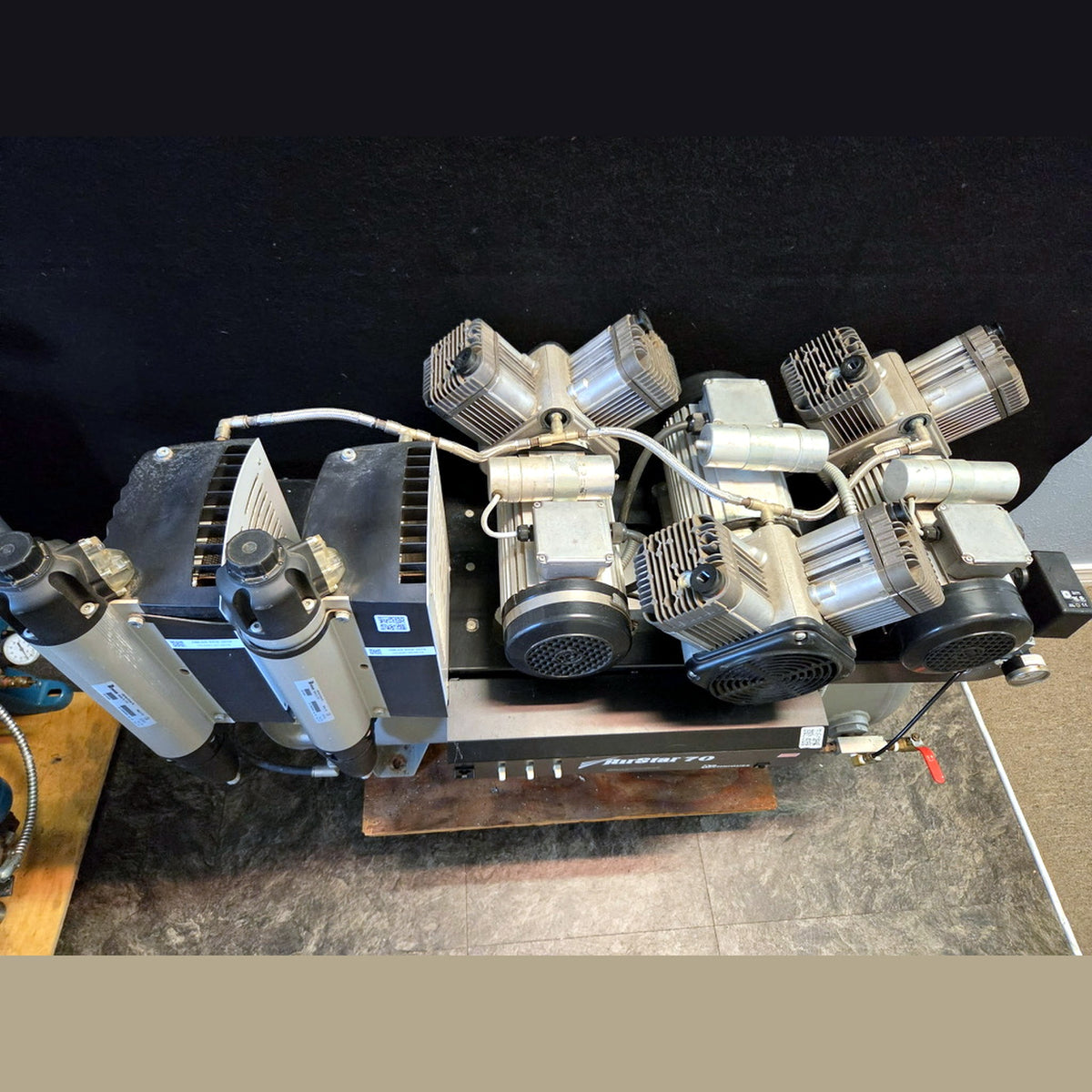 Air Techniques AirStar 70 AS70 compressor head bank from above, three 1.5 HP oil-less twin-cylinder heads with cooling fans and twin membrane dryer columns