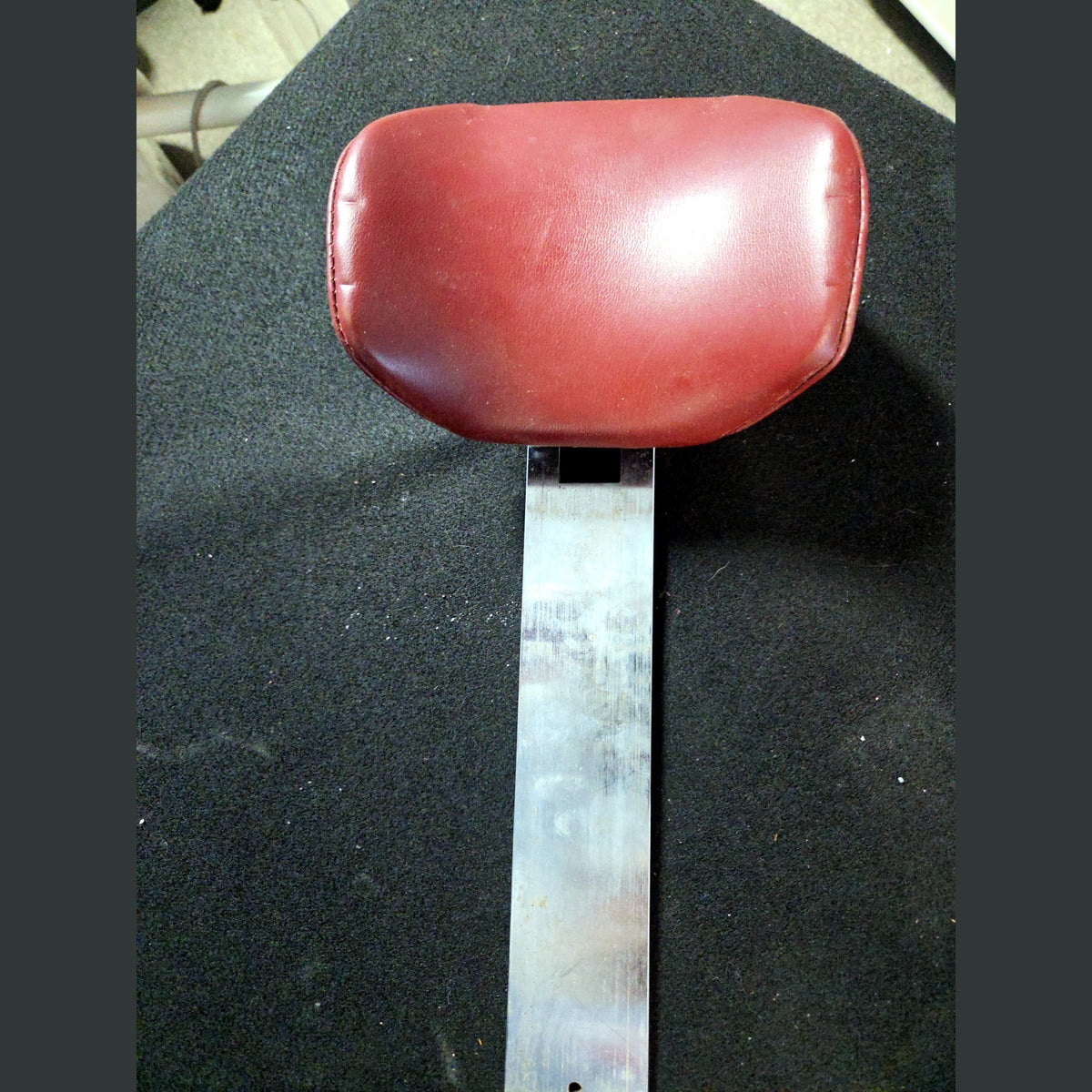 Midmark double articulating dental chair headrest, burgundy cushion, front view