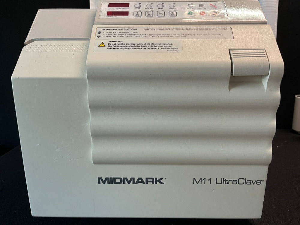 Midmark M11 UltraClave sterilizer with the door closed, three-quarter view showing the MIDMARK M11 UltraClave badge and the membrane keypad on top